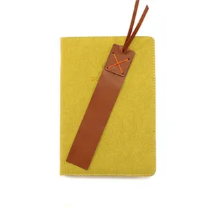 Vintage yellow notebook with brown PU leather bookmark and orange stitch detail stationery.