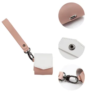 Close-up details of pu leather wireless earphone case, charging port and metal clasp hook.