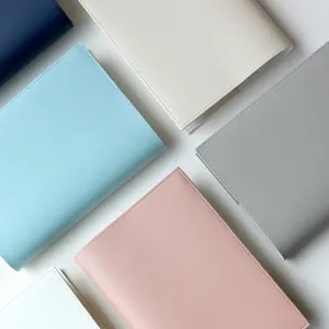 PU leather notebook cover detail view showcasing multiple colorful book protectors in clean aesthetic.