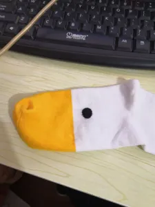 Funny cute goose head design novelty socks with yellow toe and dot for daily casual wear.