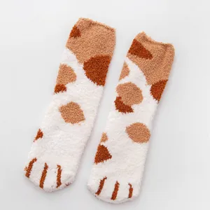 Fluffy coral fleece cat paw socks detail, soft cozy winter warm sleeping floor socks texture.