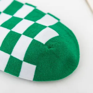 Green and white checkered sock detail, cozy knit texture and stylish pattern for women.