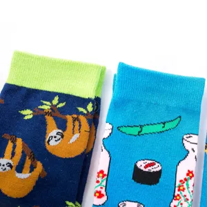 Close-up detail of colorful cartoon cotton crew socks featuring cute sloths and Japanese sushi.