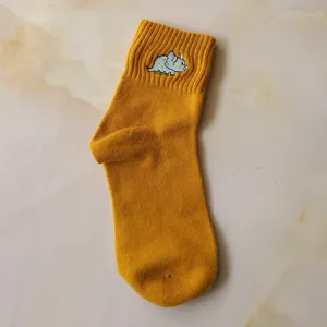 Yellow cotton women mid-calf socks featuring cute embroidered dinosaur design for daily wear.