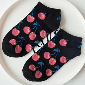 Detailed view of black cotton ankle socks featuring playful pink cherry prints, stylish daily wear.