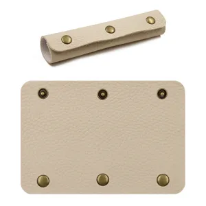 Beige PU leather handle wrap cover detail view with vintage bronze metal snap buttons.