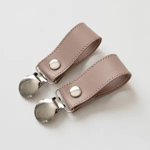 Pink leather stroller blanket clips equipped with stainless steel duckbill clips for baby.