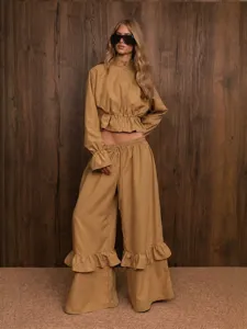 Detailed view of the khaki two-piece outfit featuring ruffles, stand collar and wide-leg pants.