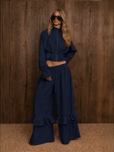Dark blue two-piece casual set featuring a zip-up cropped top and ruffle wide-leg trousers.