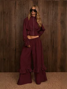 Burgundy two-piece set featuring a stand-collar zip crop top and ruffle wide-leg pants.