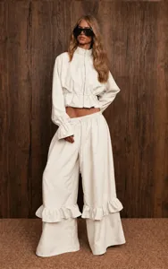 Casual two-piece set featuring a stand collar zip top and ruffled wide-leg pants.