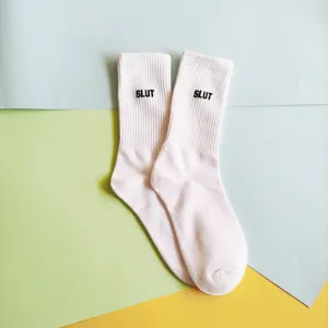 White crew socks with letter embroidery, comfortable casual cotton socks for daily wear.