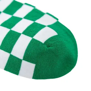 Green and white checkered fashion women socks close up detailed knit sock design view.