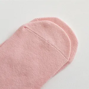 Close up detail view of pink knitted socks showing soft texture and comfortable daily wear.