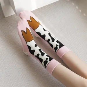 Cute pink cow print mid-calf socks with playful cartoon cowboy boot design for women