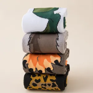 Detail view of stacked novelty animal paw crew socks with fun printed patterns for autumn.