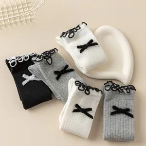 Detailed view of Japanese sweet style lace bow mid-calf knit socks in classic colors.