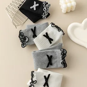 Close-up detail of cute Japanese style bow lace mid-calf socks with delicate knitted texture.