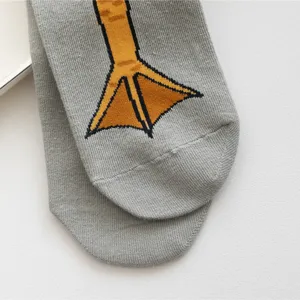Comfortable grey cotton mid-tube socks featuring a funny yellow duck foot knit pattern.
