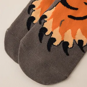 Close-up detail of cute cartoon tiger paw winter socks, showing soft knit texture and design.
