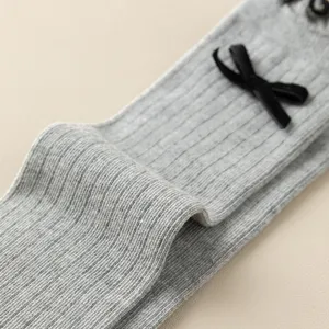 Grey knit calf socks featuring a sweet black bow detail, rib textured breathable fabric.