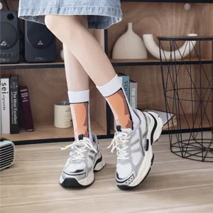 Detail shot of funny animal pattern mid-tube socks paired with stylish chunky sneakers in room.