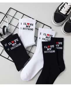 Couple cotton socks detail shot, black and white mid-tube socks with cute letter embroidery.