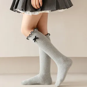 Japanese style cute knee-high socks with sweet black bow and ruffled lace trim for women girls.