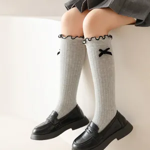 Grey knee-high socks for girls, sweet bow accent, frilly cuff knit hosiery, Japanese style.