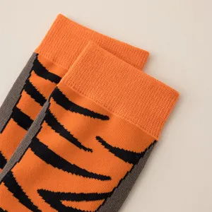 Detail view of cute tiger stripe mid tube socks in orange and black, cozy autumn wear.