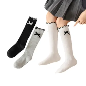 Cute girls knee high socks with sweet bow and ruffle edge design, breathable cotton knit hosiery.