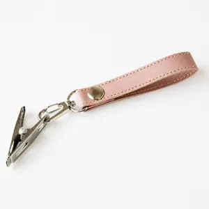 Pink leather baby shoe clip and stroller strap, durable metal clasp for secure use.