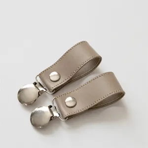 Stroller blanket clips with leather strap and metal duckbill clips for baby daily use.