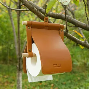 Outdoor camping hanging leather toilet paper holder detail shot, portable brown tissue bag case.