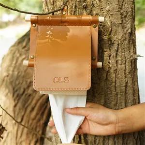 Creative hanging leather toilet paper holder with wooden stick for home and outdoor use.