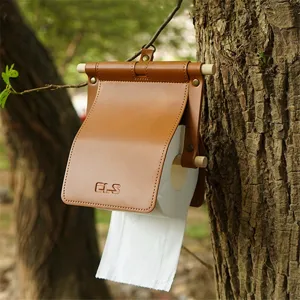 Outdoor leather toilet paper holder detail, hanging wooden stick tissue cover for camping.