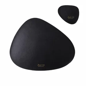 Detailed view of irregular black oval placemat set, heat resistant dining table mat.