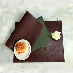 Detail view of the waterproof heat-resistant faux leather placemat with textured crocodile pattern.