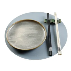 Round leather placemat detail, oil-proof and heat-insulating tableware mat for dining setup.
