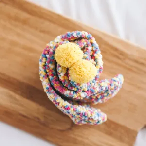 Detailed view of cute fuzzy candy-colored women's winter warm sleeping socks with yellow pom-poms.