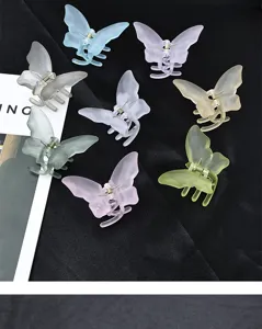 Frosted acrylic butterfly hair claw clips in assorted vibrant solid colors for women.