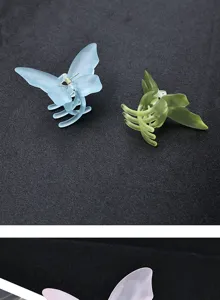 Detailed view of frosted acrylic butterfly hair claws in pastel colors, elegant half updo accessory.