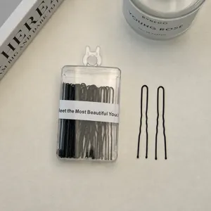 Black U-shaped hairpins set with clear storage box, ideal for hairstyling and bobby pins.