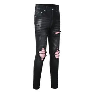 Black distressed men's skinny jeans with pink patch details, stylish casual denim trousers.