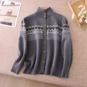 Grey button-down cardigan sweater detail, featuring cozy Fair Isle heart knit pattern.