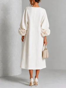 Back view detail of elegant white linen maxi dress featuring stunning 3D floral lantern sleeves.