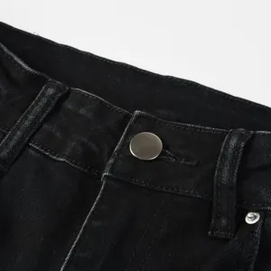 Black washed denim jeans waistband detail, durable fabric with classic metal button closure.