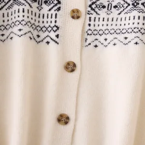 Detailed view of cream knit cardigan featuring black geometric Fair Isle pattern and buttons.