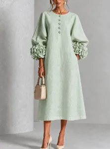 Detailed view of the elegant light green midi dress featuring 3D flower lantern sleeves.