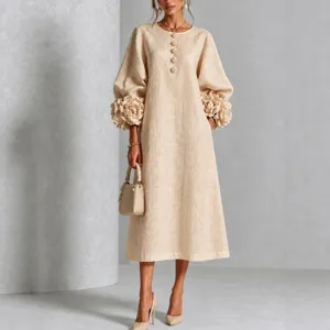 Elegant beige midi dress featuring lantern sleeves, floral cuffs, and chic button details.